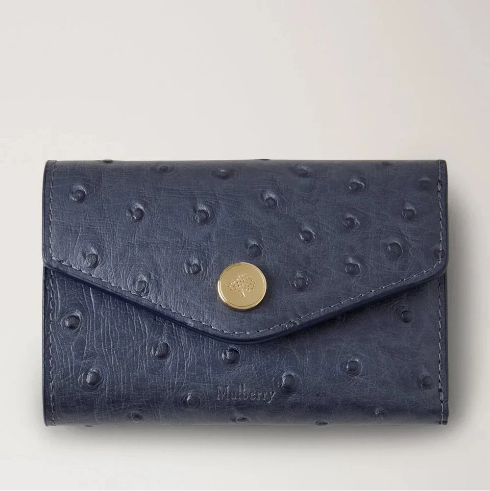 Mulberry Folded Multicard Wallet Ostrich Stormy Blue shows an exclusive wallet in blue dotted leather with brass clasp. Model RL8946738U918.