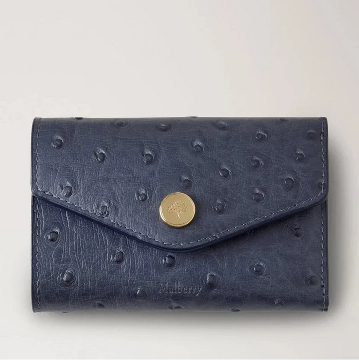 Mulberry Folded Multicard Wallet Ostrich Stormy Blue shows an exclusive wallet in blue dotted leather with brass clasp. Model RL8946738U918.
