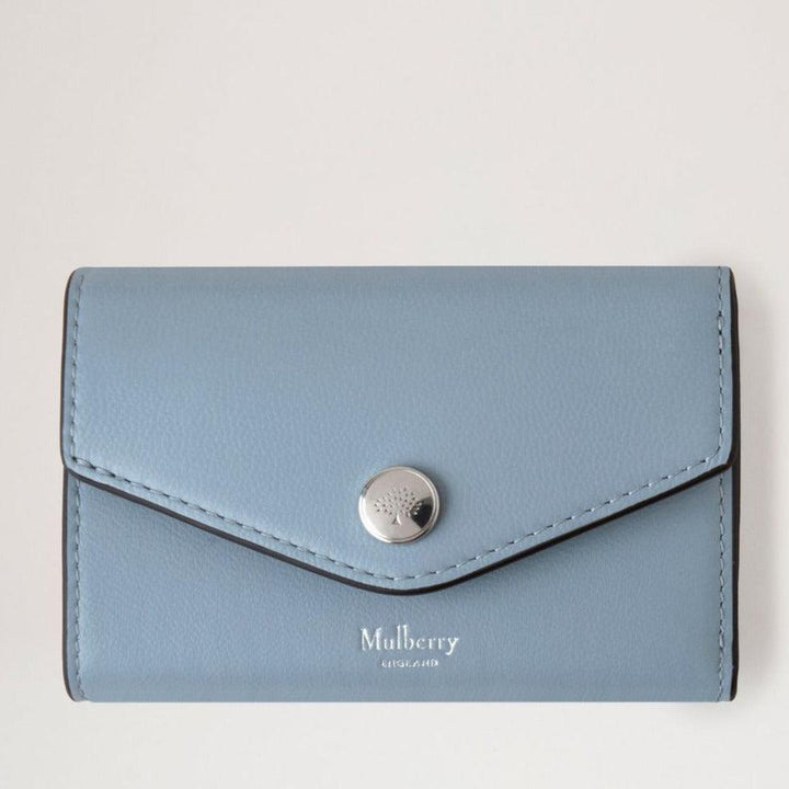 Mulberry Folded Multicard Wallet Poplin Blue shows a light blue leather wallet with silver press stud, Model RL7841587U804.