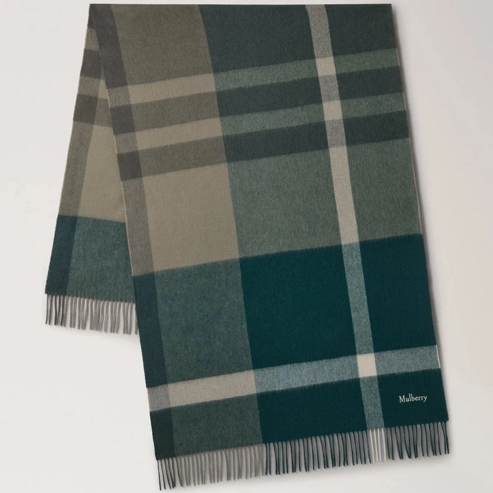 Mulberry The Large Check Merino Wool Scarf is shown in shades of green with a checkered pattern and fringes. Modelvs4295889q750