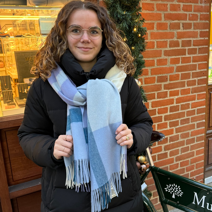 Mulberry Large Check Merino Wool Scarf poplin blue/white shown around the neck of woman in front of store, Model VS4295889U910