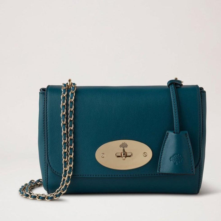 Mulberry Lily Micro Classic Grain Titanium Blue shows a small blue leather shoulder bag with gold chain. Model HH9179587T622