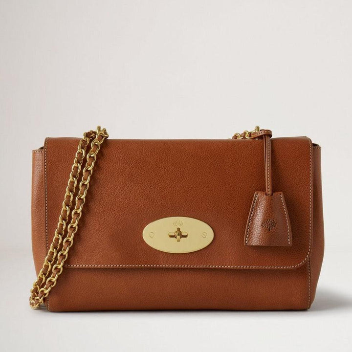 Mulberry Medium Lily Legacy NVT Oak shows a medium brown leather bag with chain strap and gold-tone clasp. Model HH7944275G110.