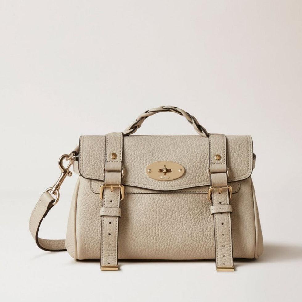 Mulberry Mini Alexa Chalk shows a light beige leather bag with braided handle, gold buckles and adjustable strap. Model rl6595736w160