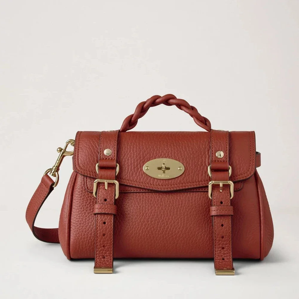 Mulberry Mini Alexa Heavy Grain Rust shows a small crossbody bag in rust red leather with braid detail, Model RL6595736L190.
