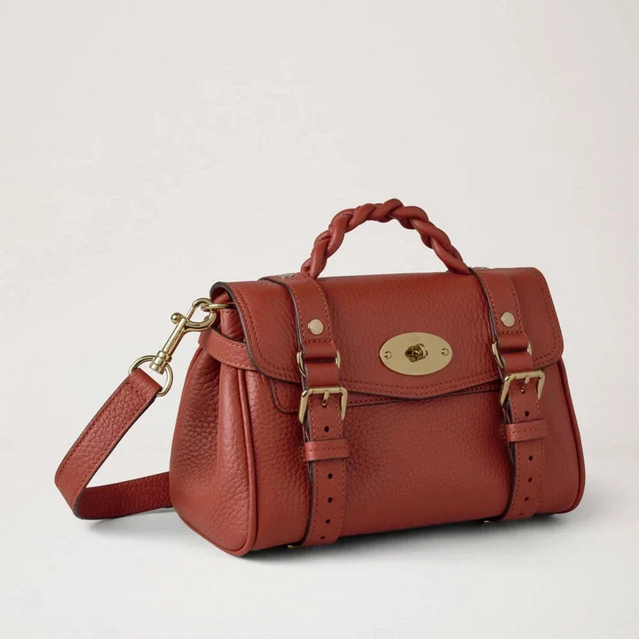 Mulberry Mini Alexa Heavy Grain Rust shows a small, rust-colored leather bag with braided handle and gold-colored details. Model RL6595736L190