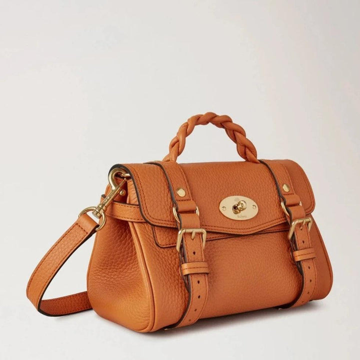 Mulberry The Mini Alexa Heavy Grain Sunset is shown in heavy orange leather with braided handle and gold detailing. Model RL6595736N691.