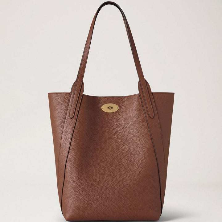 Mulberry North South Bayswater Heavy Grain Bright Oak showcases a roomy brown leather bag with two handles and gold detailing. Model hh9104736g222.