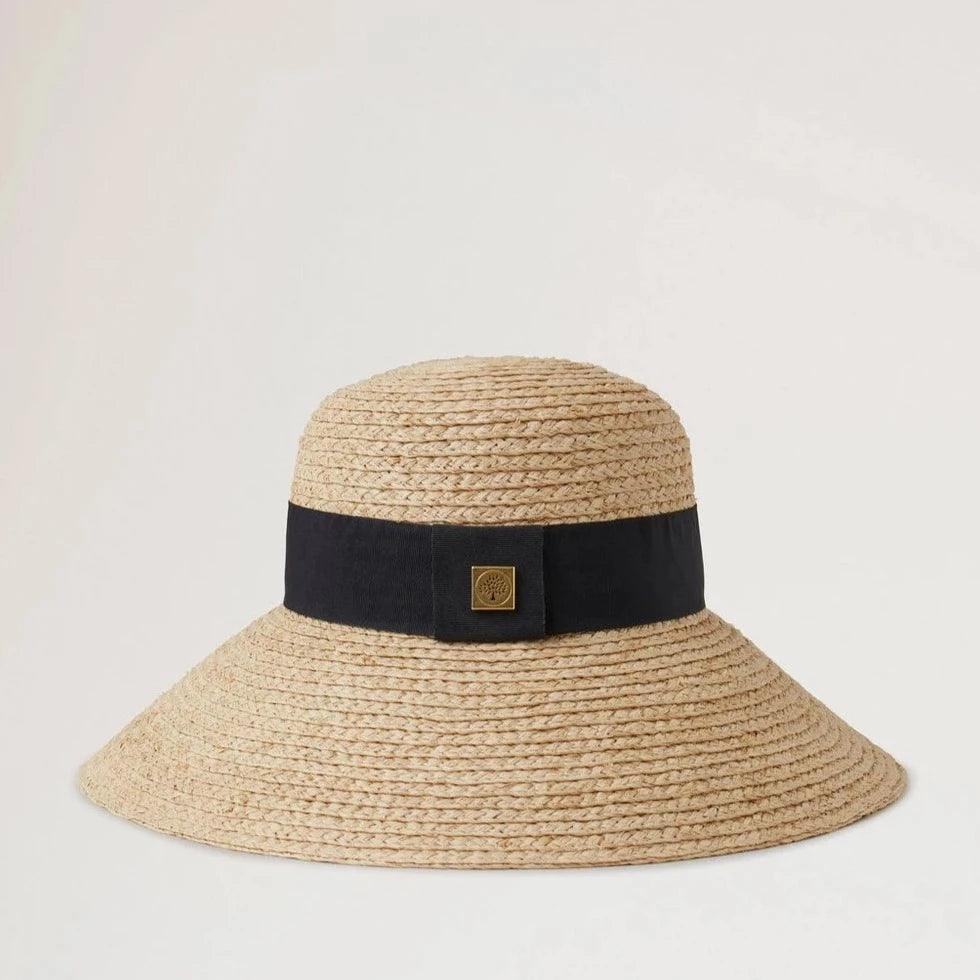 Mulberry Raffia Sun Hat Wide Brim shows a natural colored straw hat with a wide black band. Model VH4136060H120-001-1