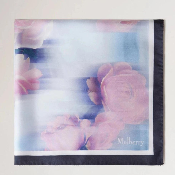 Mulberry Rose and Blue Border Square Scarf shows a floral silk scarf in shades of pink and blue with a dark border. Model VS4804032U804