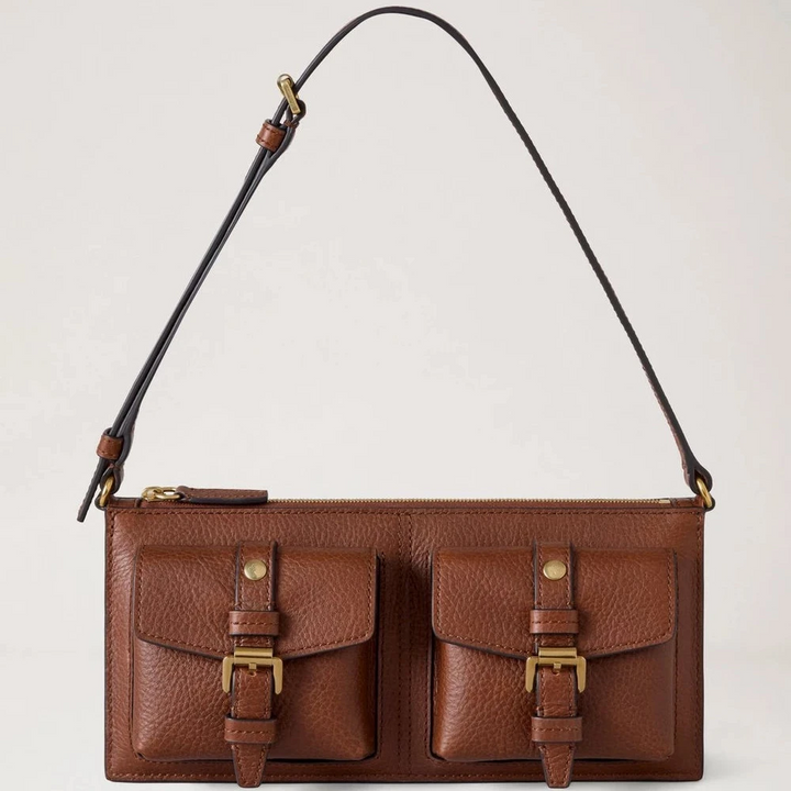 Mulberry Roxanne Mini Shoulder Bag Heritage NVT Oak shows a brown leather shoulder bag with two front pockets and gold buckles. Model RL8902730G110.