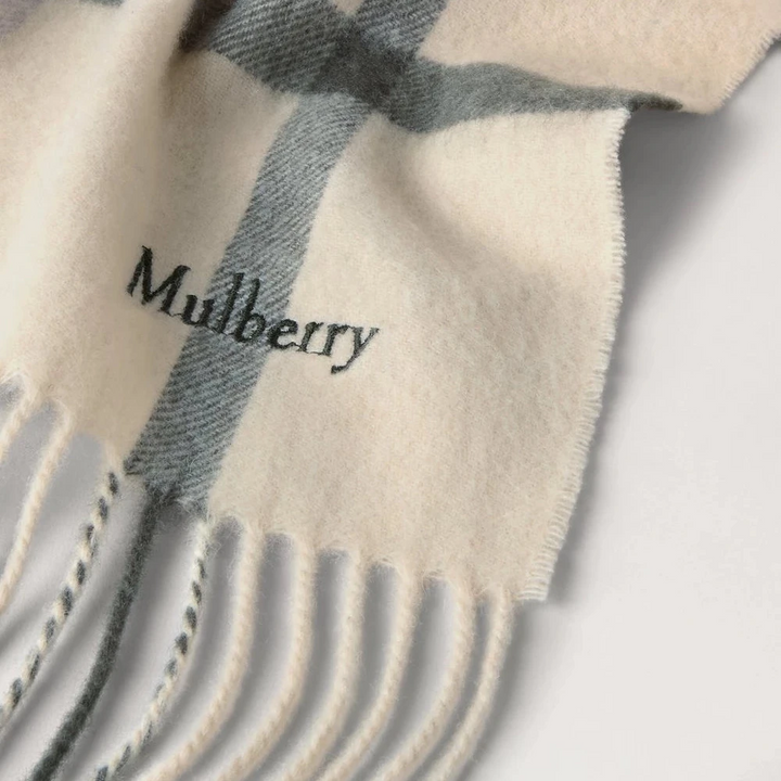 Mulberry Small Check Merino Wool Scarf shows wool scarf in eggshell and olive check with fringes. Model VS4319890W563