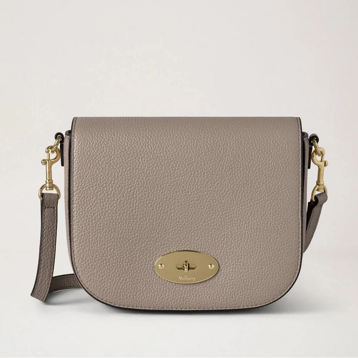 Mulberry Small Darley Satchel Small Classic Grain Cashmere Taupe shows a taupe colored leather bag with a gold colored buckle and adjustable strap. Model RL4957/205F924