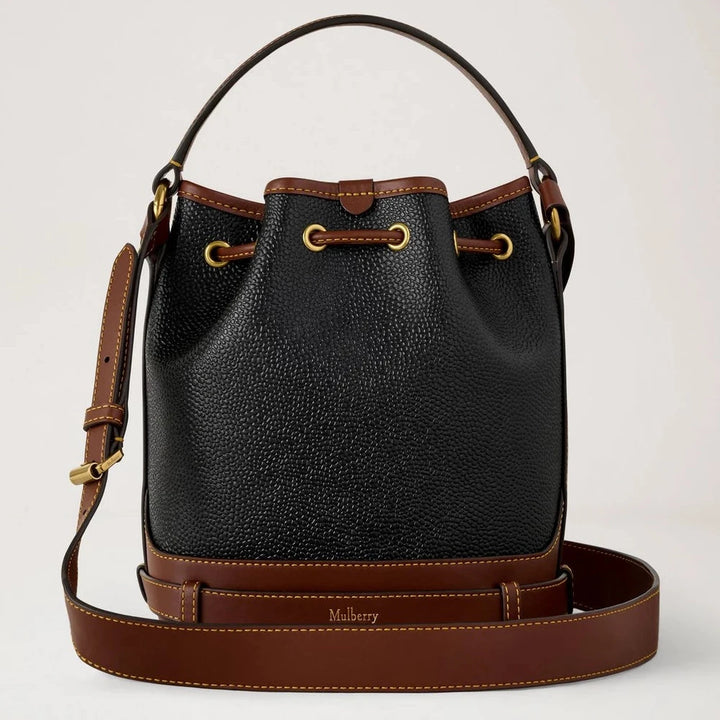 Mulberry Small Scotchgrain Bucket shows black and cognac colored bag in structured material with adjustable strap. Model HH0017127A340.