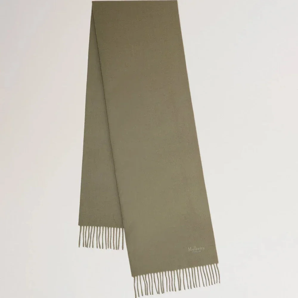 Mulberry Small Solid Merino Wool Scarf Linen Green shows a plain, greenish wool scarf with fringes. Model VS4318946R563.