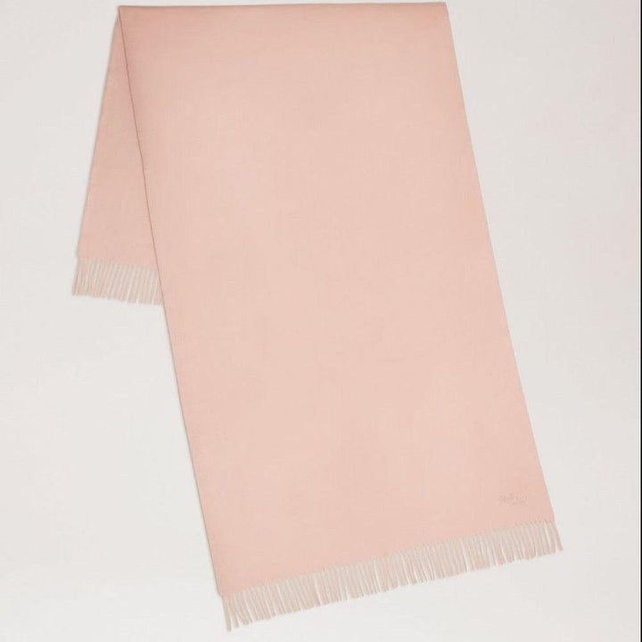 Mulberry Solid Merino Wool Scarf Rosewater showcases a simple, bright pink wool scarf with fringes. Model VS4240947J633