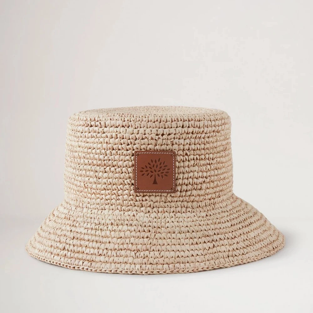 Mulberry Summer Raffia Bucket Hat showcases a bright braided raffia summer hat with leather front detail. Model VH4097807H120