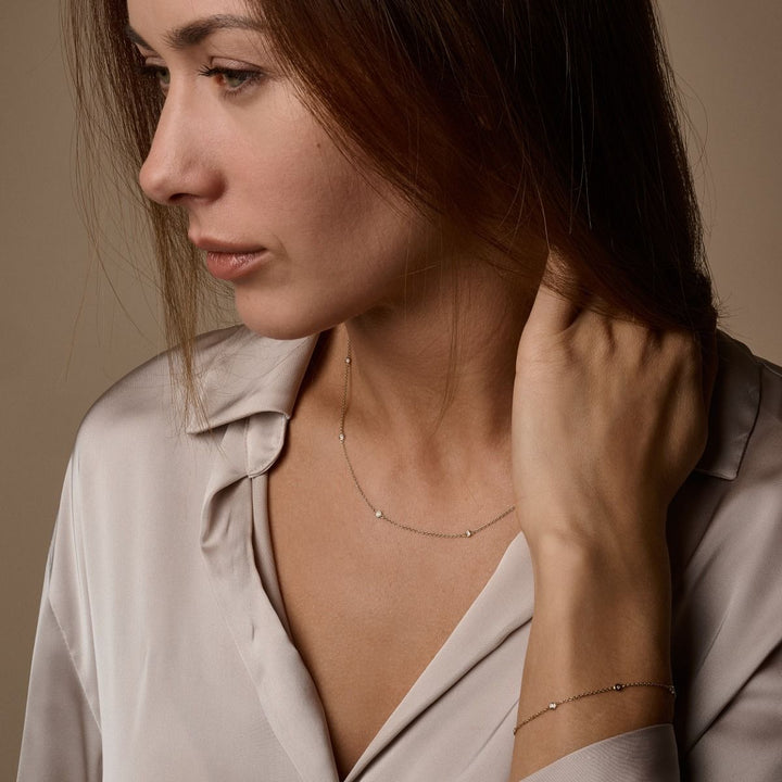 Nuran Zoe 14kt bracelet with diamonds worn on wrist by woman in light brown shirt. Model b1002-0125-2