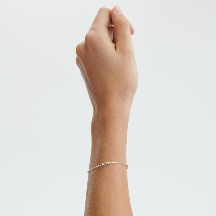 Pernille Corydon Caia Bracelet in silver shown on model hand, simple and feminine style. Model B-730-S