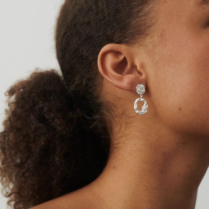 Pernille Corydon Cloud Silver Earrings shown on ear, elegant hammered silver finish. Model E-566-S-1
