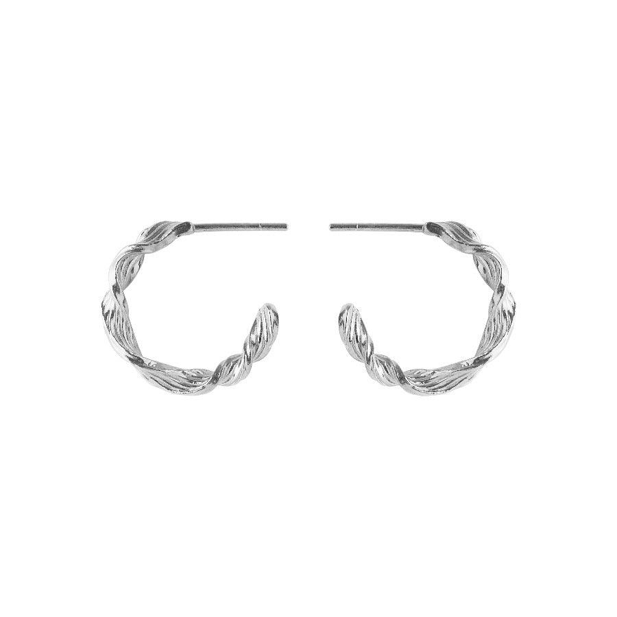 Pernille Corydon Dancing Wave Hoops in silver appear as elegant twisted earrings. Model E-489-S