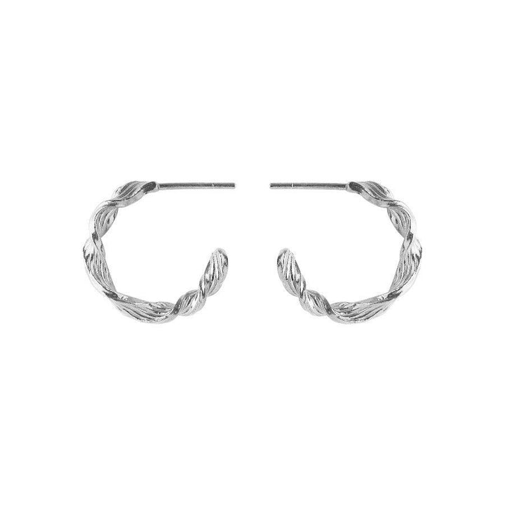 Pernille Corydon Dancing Wave Hoops in silver appear as elegant twisted earrings. Model E-489-S