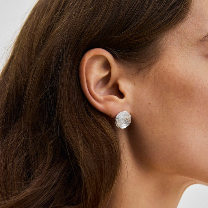 Pernille Corydon Large Rose earrings in silver are worn on the ear, detail of glossy and elegant design. Model E-537-S