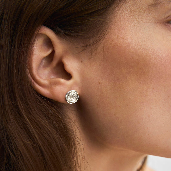 Pernille Corydon Medium Rose Earrings in silver appear on ear, matte, elegant design. Model E-536-S.