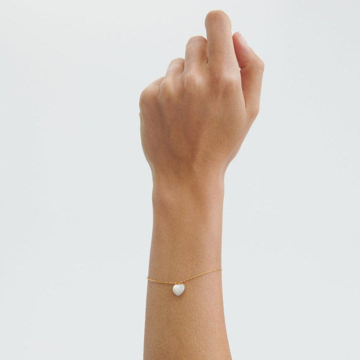 Pernille Corydon Ocean Heart Gold Plated Bracelet Shown on Wrist with White Heart Pendant, Model B-387-GP