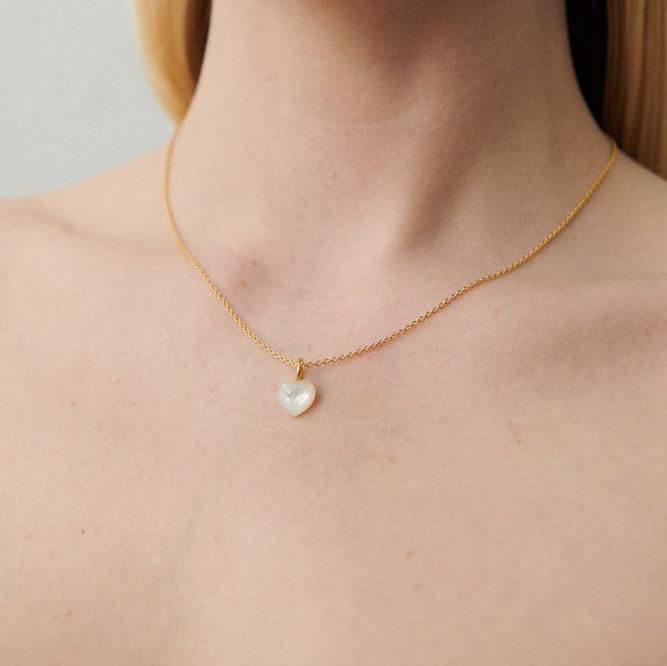Pernille Corydon Ocean Heart gold-plated necklace with mother-of-pearl heart pendant on model. Model N-387-GP-1.