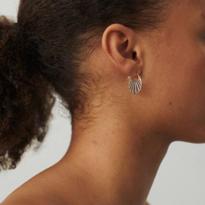 Pernille Corydon Small Misty Light silver creoles shown on ear in neutral light, Model e-613-s-1