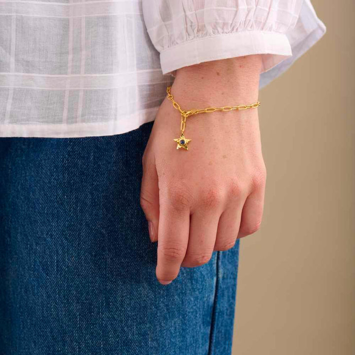 Pernille Corydon Twinkling Star Bracelet in gold-plated silver with star pendant on wrist. Model B-382-GP