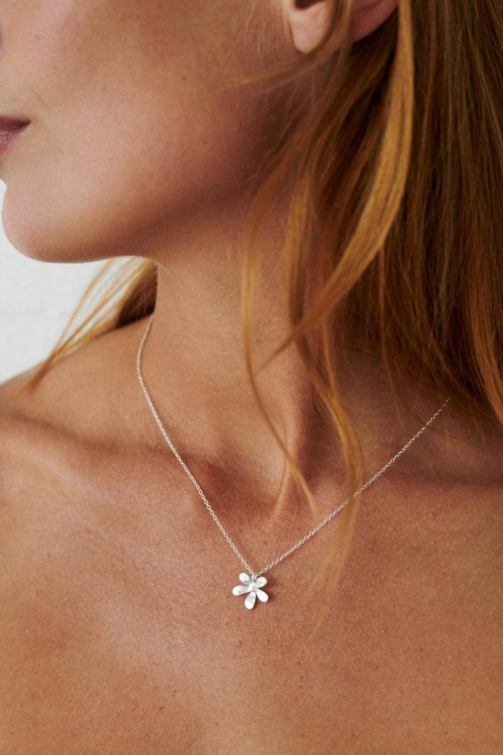 Pernille Corydon Wild Poppy necklace in silver worn around the neck, flower pendant, Model N-363-S-2.