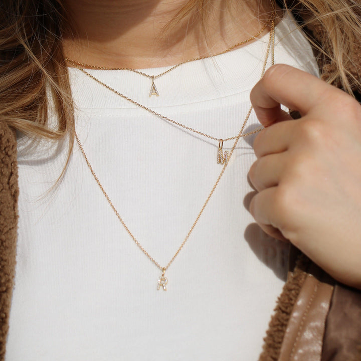 ro copenhagen my collection with diamonds, gold necklaces with letter pendant worn on white blouse, Model p114y2-001-2