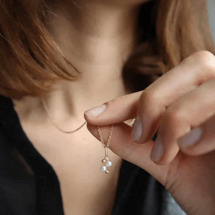 RO Copenhagen Orbit Dot Pearl pendant 0.015ct TWVS worn on necklace, elegant design in gold. Model p118y102-2