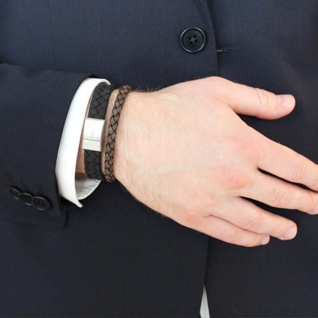 Son of Noa men's bracelet shown on a man's hand, braided dark brown leather and steel buckle. Model 80970149121