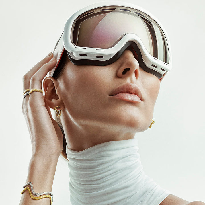 studio-z-rime-gold-plated ring shown on model with gold jewelry, white blouse and ski goggles. Model 7240948-001-1
