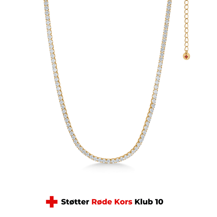 studio-z-tennis-necklace-in-gold-plated-sol-30-36cm-7227000, elegant tennis chain in gold-plated silver with clear stones on a green background. Model 7227000