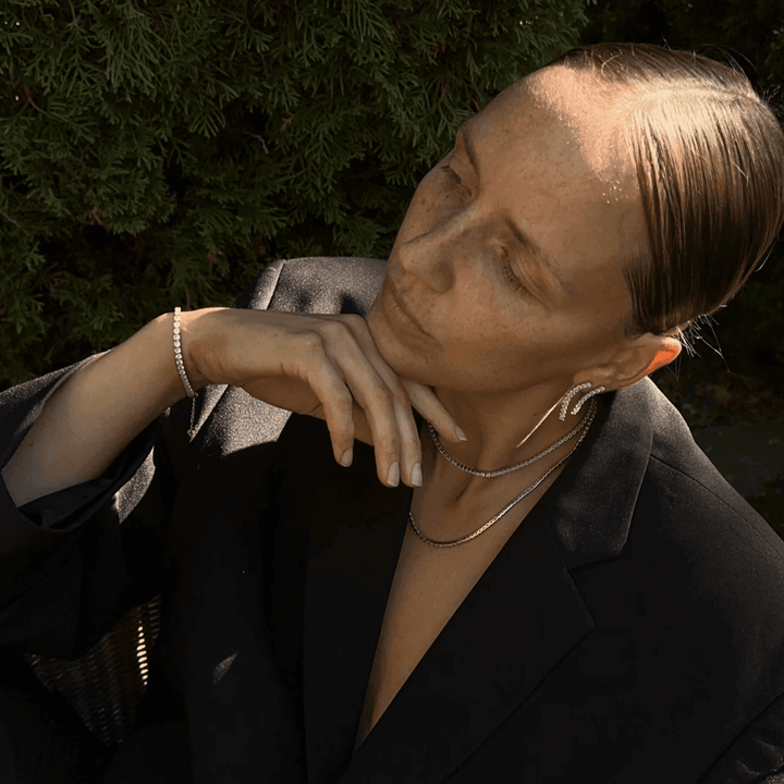 Studio Z Tennis necklace in gold-plated silver worn by model outdoors with black blazer, Model 7227000-2.