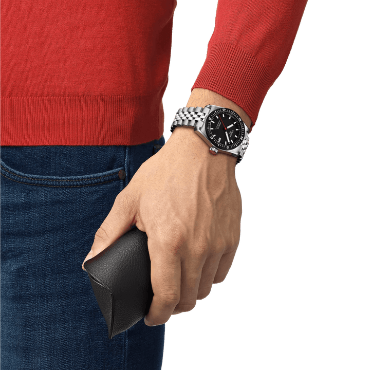 Tissot PR516 Powermatic 80 with black dial worn on wrist, steel link, Model T1494071105100