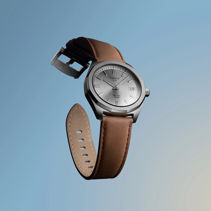 Tissot PRC 100 Solar Quartz 39mm brown leather strap, silver dial on blue background. Model T1514221603100