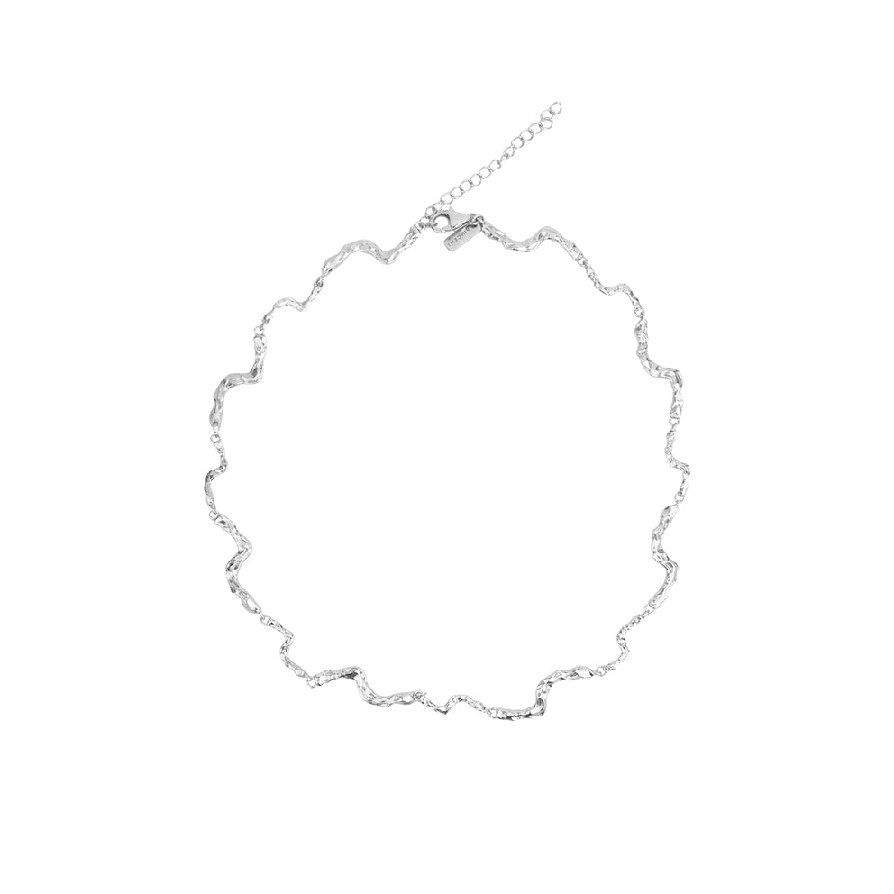 Vincent Nightfall Silver Necklace shown on white background with wavy, shiny silver structure. Model VJ127