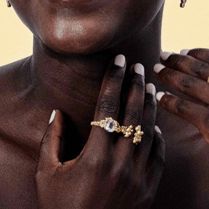 Vincent Orb Chronicles Gold Plated Ring Shown On Hand, Elegant Design With Clear Stone, Model VJ163-URG-001-2.