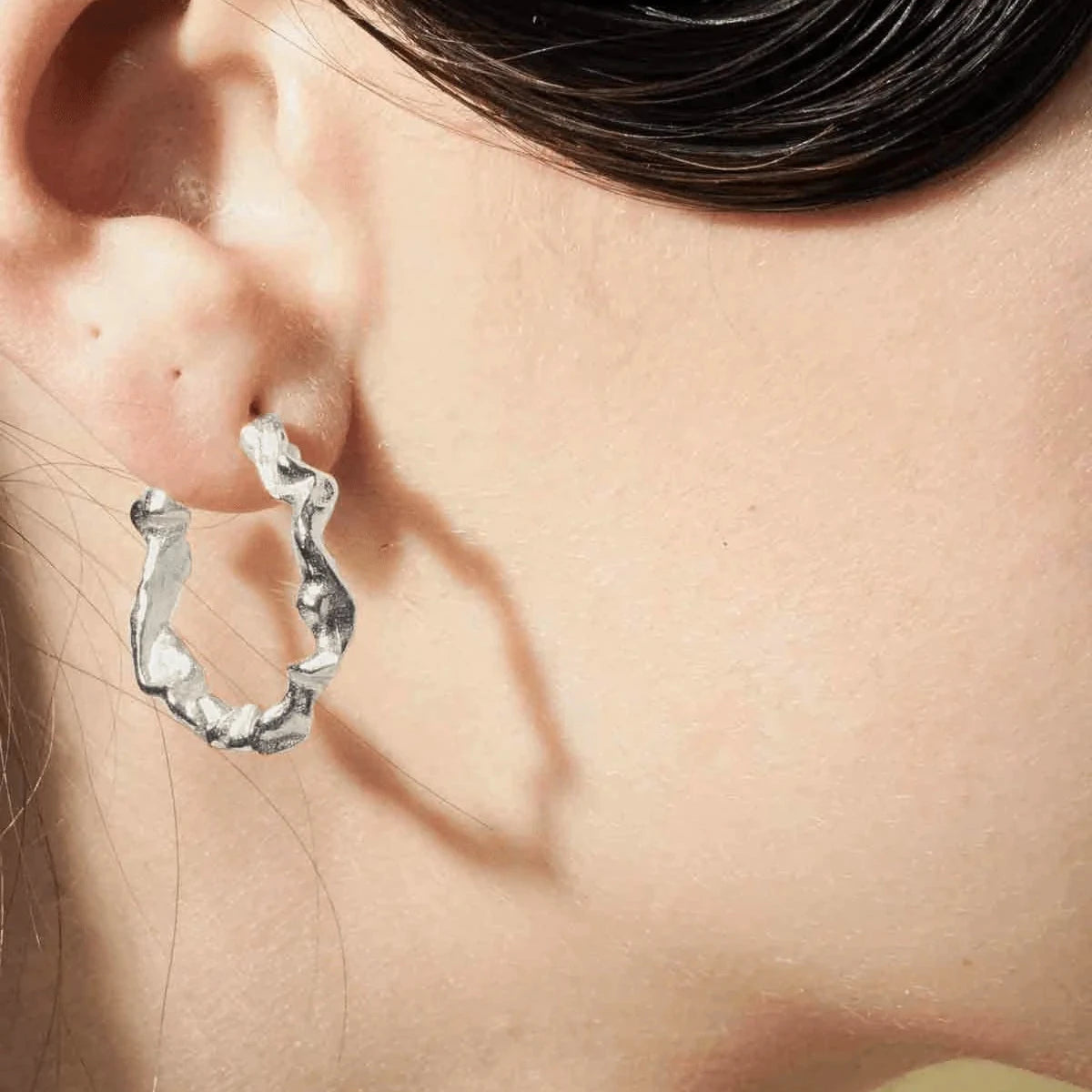 Vincent Shaman Solv Hoops Earrings 25mm shown in silver on ear, organic form. Model vj126-ues-l-1.