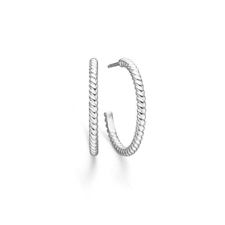 Mads Z Silver Poetry Creole shows a set of elegant silver creoles with a twisted surface. Model 2110047-2110047