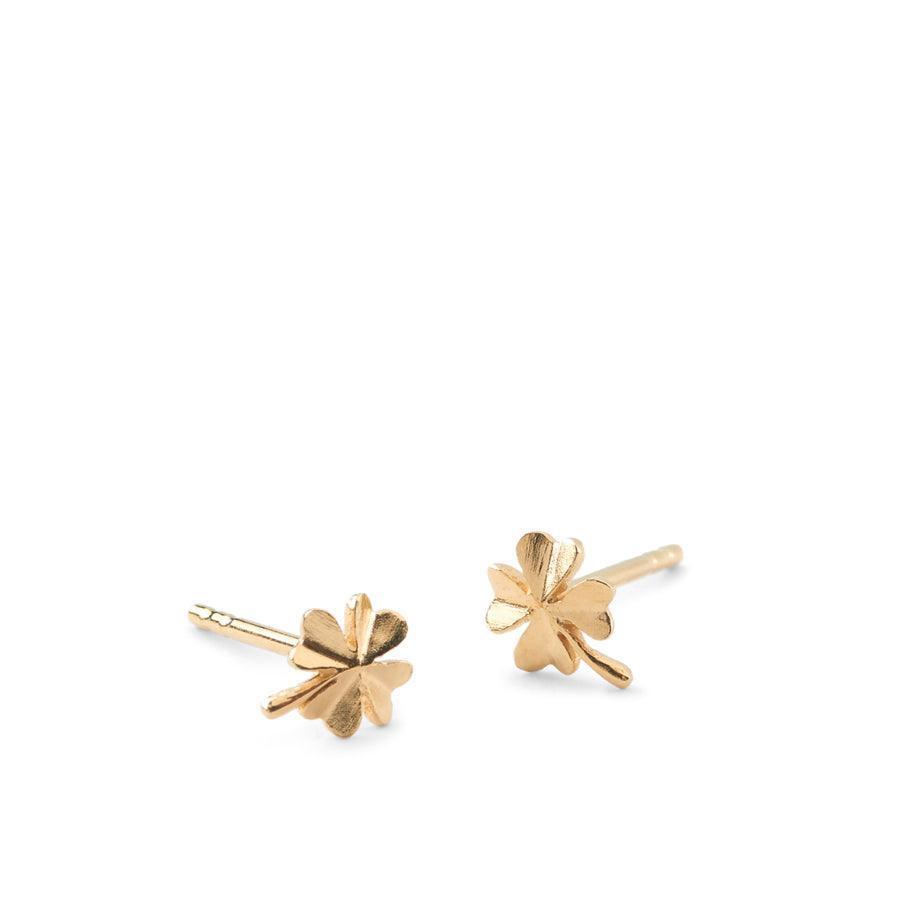 Pernille Corydon Clover Studs shown as a pair of small, golden four-leaf clover studs in a brushed finish. Model E-320-GP