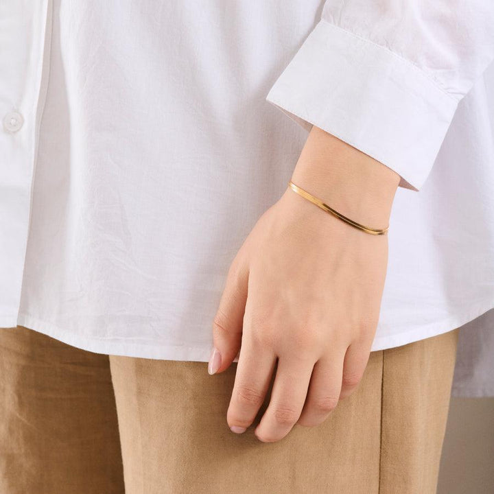 Pernille Corydon Thelma Bracelet is worn on the wrist, slim gold colored bracelet. Model B-698-GP
