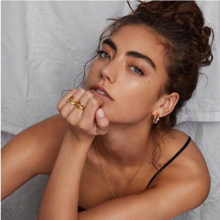 Polar Jewelry Cosmos Gold Plated Hoop Single appears worn by woman, elegant and golden. Model COS-HP-GD-WZ-00403