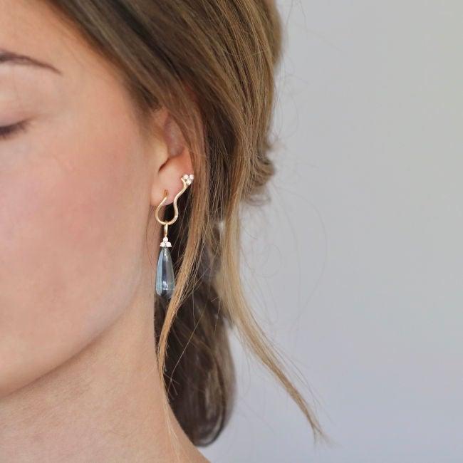 Ro Copenhagen 18kt Fryd Wave Diamond Earrings show elegant gold earring with diamonds on ear, Model 108105-2.